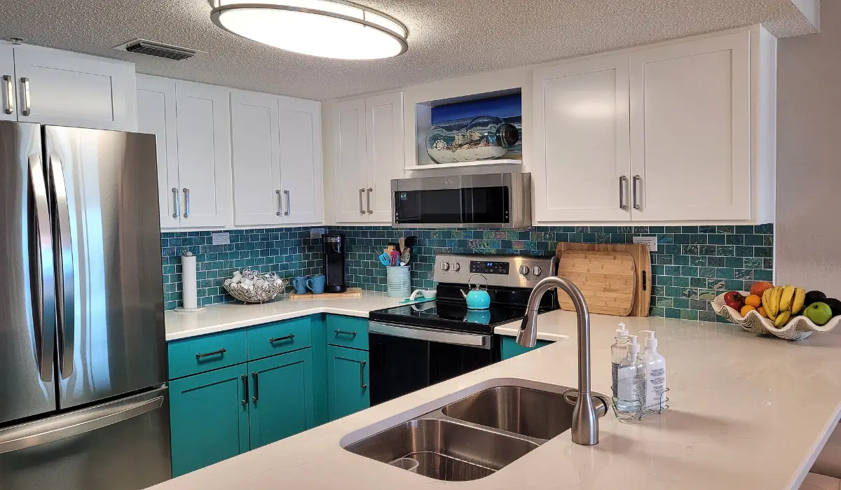 Modern kitchen with colorful cabinets, Utah mountain backdrop.
