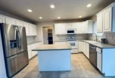 Inspect cabinet painting quality Finished white kitchen cabinets after painting inspected for quality and durability