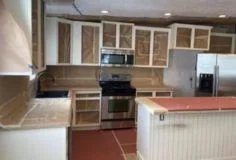 Prep surfaces for cabinet painting Kitchen prepared for cabinet painting with doors removed and surfaces covered