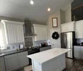 Painted white kitchen cabinets with center island, showcasing a modern cabinet refinishing project in Salt Lake City.